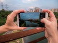 Taking Pictures with the Mobile of Pinheiros River and Polluted Waters surrounded by offices