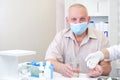 Taking pills, a glass of water in the hand of an elderly person Royalty Free Stock Photo