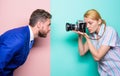 Taking a portrait. Businessman posing in front of female photographer. Fashion shooting in photo studio. Pretty woman Royalty Free Stock Photo