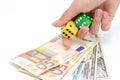 Taking a risk and winning concept with a pair of dice and money Royalty Free Stock Photo