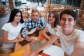 Taking a selfie. Four young students in casual clothes have meeting at rainy day Royalty Free Stock Photo