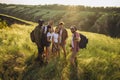 Taking selfie. Group of friends, young men and women walking, strolling together during picnic in summer forest, meadow Royalty Free Stock Photo