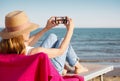 Taking a selfie on their phone at the beach Royalty Free Stock Photo