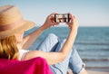 Taking a selfie on their phone at the beach Royalty Free Stock Photo