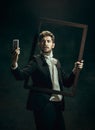 Young man as Dorian Gray on dark background. Retro style, comparison of eras concept.