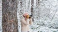Taking stunning winter photos. Enjoy beauty of snow scenery through photos. Woman photographer with professional camera
