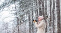 Taking stunning winter photos. Winter hobby. Enjoy beauty of snow scenery through photos. Woman photographer with