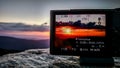 Taking sunset photo with a camera in the mountains