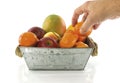 Taking tangering from fruit bowl Royalty Free Stock Photo