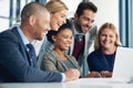 Taking their business beyond as a team. a group of businesspeople working together on a laptop in an office. Royalty Free Stock Photo