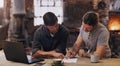 Taking their time to iron out the details. two men discussing paperwork while sitting together in a workshop. Royalty Free Stock Photo