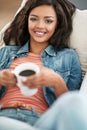 Taking things easy today. High angle portrait of a young woman drinking a cup of coffee at home. Royalty Free Stock Photo
