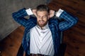 Taking time for a minute break. Cheerful young man holding hands behind head and keeping eyes closed while sitting at his working Royalty Free Stock Photo