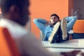 Taking time for a minute break. Cheerful young man holding hands behind head Royalty Free Stock Photo