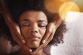 Taking the time to just unwind. a young woman getting a head massage at a beauty spa. Royalty Free Stock Photo