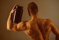 Taking vitamins for a healthy diet. Muscular man with vitamin supplements. Strong man hold supplement bottle