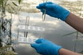 Taking a water test for analysis from a reservoir.