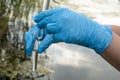 Taking a water test for analysis from a reservoir. Royalty Free Stock Photo