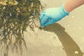 Taking a water test for analysis from a reservoir.