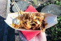 Takoyaki in hand women in Osaka Japan. Close up. Street food