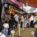 Takoyaki Restaurant in Dontonbori district with tourists. Royalty Free Stock Photo