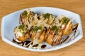 Takoyaki, typical fried octopus meatballs, Osaka`s culinary culture, garnished with cheese sauce, soy sauce and Katsuobushi, okak