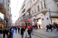 Taksim Tunel Nostalgia Tram trundles along the istiklal street and people at istiklal avenue. Istanbul, Turkey