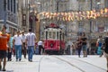 Taksim Tunel Nostalgia Tram trundles along the istiklal street and people at istiklal avenue, Istanbul, Turkey