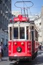 Taksim Tunel Nostalgia Tram trundles along the istiklal street and people at istiklal avenue. Istanbul, Turkey