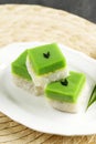 Talam Ketan or Kuih Seri Muka,  Two Layered Dessert with Steamed Glutinous Rice at the Bottom and Green Custard Layer Cake Royalty Free Stock Photo