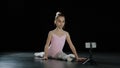 Talanted ballerina girl gymnast acrobat sits in twine doing back bend shoots video blog vlog online lesson on mobile Royalty Free Stock Photo