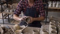 Talanted caucasian man making decoration for cap.