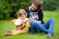 Talanted toddler girl learn to play ukulele guitar