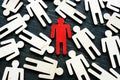 Talent acquisition concept. Red figure stand out from the crowd. Royalty Free Stock Photo