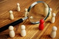 Talent acquisition and management. Magnifying glass and figurines Royalty Free Stock Photo