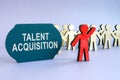 Talent acquisition written on dark plate and wooden figurines.