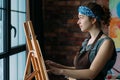 Talent inspired female artist easel painting