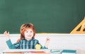 Talented child. Kid is learning in class on background of blackboard. Learning and education concept. Home school for Royalty Free Stock Photo