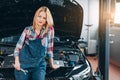 Talented female mechanic is ready to give a hand in repairing your car