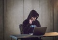 Talented hacker using laptop computer while working in dark office Royalty Free Stock Photo