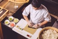 Talented male chef decorating sushi