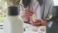 Talented painter looking nature drawing picture outdoor. Portrait of creative girl painting rocks in windy day