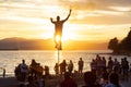 Talented Street Performer doing a show with a unicycle in front of a large crowd