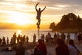 Talented Street Performer doing a show with a unicycle in front of a large crowd