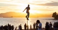 Talented Street Performer doing a show with a unicycle in front of a large crowd