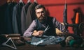 Talented tailor. business dress code. Handmade. suit store and fashion showroom. Bearded man tailor sewing jacket Royalty Free Stock Photo