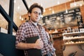 Talented young man in casual shirt drawing sketch in notebook enjoying leisure time in coffee shop.Skilled student Royalty Free Stock Photo