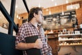 Talented young man in casual shirt drawing sketch in notebook enjoying leisure time in coffee shop.Skilled student Royalty Free Stock Photo