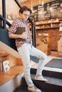 Talented young man in casual shirt drawing sketch in notebook enjoying leisure time in coffee shop.Skilled student Royalty Free Stock Photo