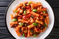 Talian Pasta Tortiglioni with eggplant, zucchini, pepper and basil in tomato sauce close-up in a plate. Horizontal top view